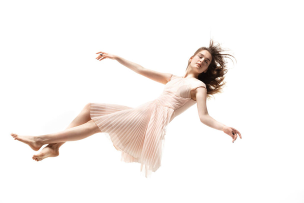 Mid-air beauty. Full length studio shot of attractive young woman hovering in air and keeping eyes closed - Foto, afbeelding