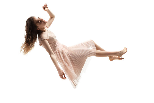 Mid-air beauty. Full length studio shot of attractive young woman hovering in air and keeping eyes closed - Foto, Imagem