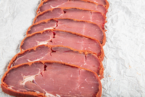 Traditional Turkish Sliced, Dry Aged Meat, Pastirma,Turkish bacon pastrami on wooden board.  - Photo, Image