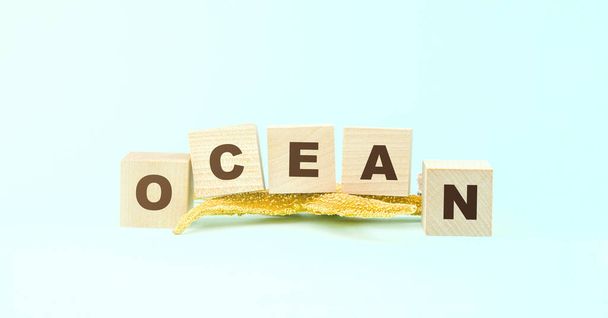 word ocean made with wooden blocks and yellow starfish - Zdjęcie, obraz