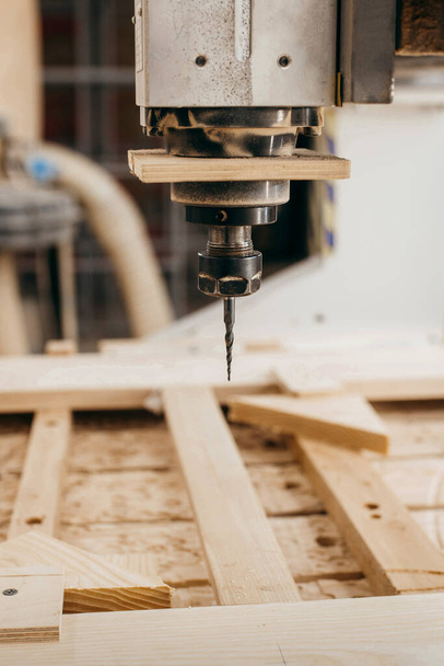 Close-up of cutting wood on a CNC milling machine in garage - Photo, image