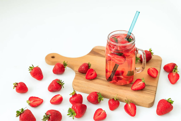 Tasty strawberry drink with berries and wooden board. Diet drink and healthy concept - Фото, зображення