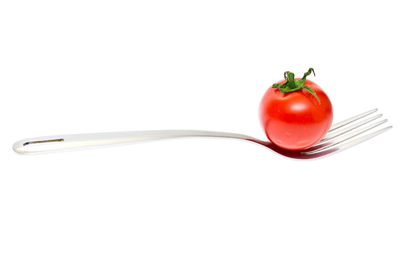 Fresh cherry tomato on fork isolated at white background - Foto, Imagen