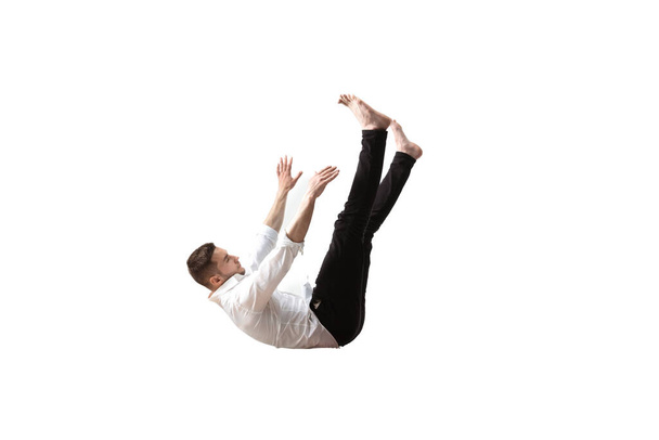 Mid-air beauty. Full length studio shot of attractive young man hovering in air and keeping eyes closed - Φωτογραφία, εικόνα