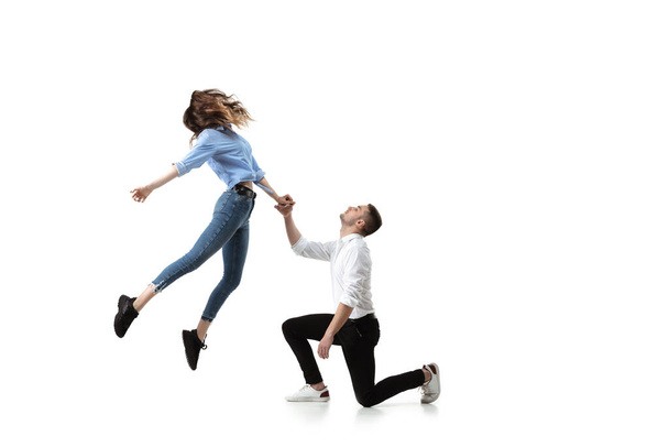 Mid-air beauty. Full length studio shot of attractive young woman and man hovering in air and keeping eyes closed - Фото, зображення