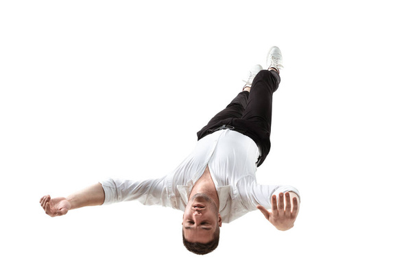 Mid-air beauty. Full length studio shot of attractive young man hovering in air and keeping eyes closed - Фото, зображення