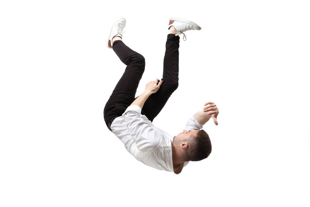 Mid-air beauty. Full length studio shot of attractive young man hovering in air and keeping eyes closed - Foto, imagen