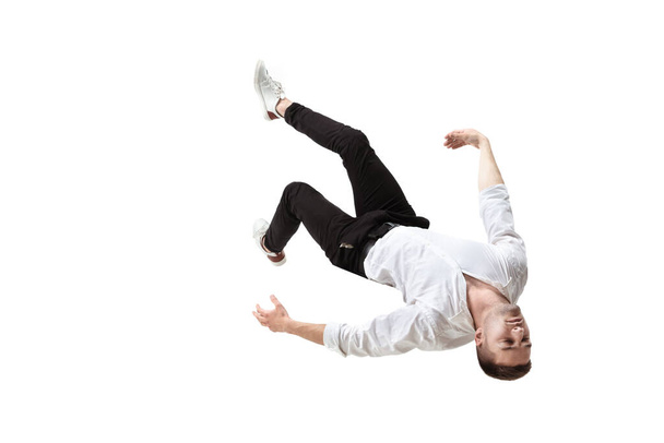 Mid-air beauty. Full length studio shot of attractive young man hovering in air and keeping eyes closed - 写真・画像