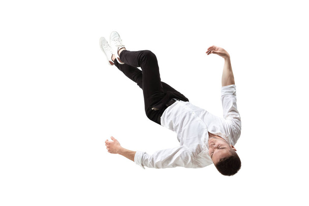 Mid-air beauty. Full length studio shot of attractive young man hovering in air and keeping eyes closed - Foto, Imagen
