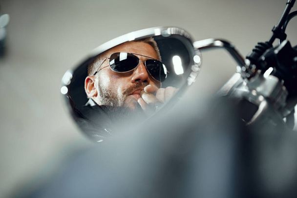 Reflection in the motorcycle mirror of a man driver in sunglasses - Foto, Bild