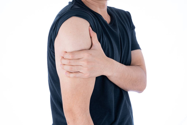 A man feeling exhausted and suffering from arm pain and injury on isolated white background. Health care and medical concept. - Photo, Image