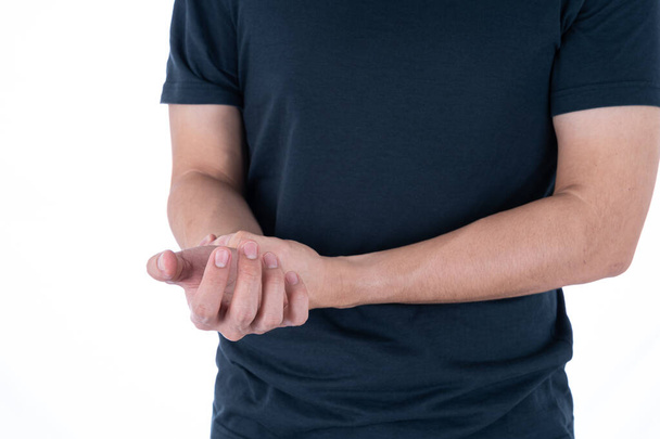 A man feeling exhausted and suffering from wrist pain and injury on isolated white background. Health care and medical concept. - Fotoğraf, Görsel