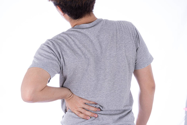 A man feeling exhausted and suffering from waist and back pain and injury on isolated white background. Health care and medical concept. - Photo, Image