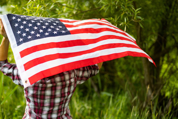 woman holding US flag independence day  - Zdjęcie, obraz