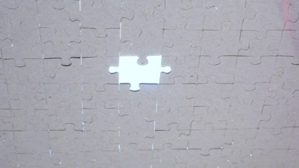 Putting the last piece of jigsaw puzzle to complete the mission. Puzzle piece coming down into its place. Business concept for key completion for business success - Footage, Video