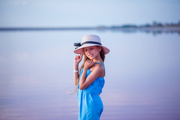 portrait of happy little girl with hat near sea. Summer vacation - Фото, изображение