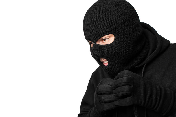 Portrait of masked thief isolated over white studio wall - Foto, Imagen