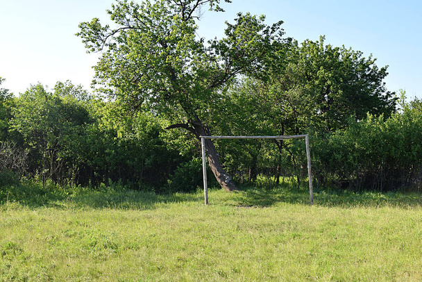 Football goal in a meadow in the countryside, made by well-known residents. - Photo, Image