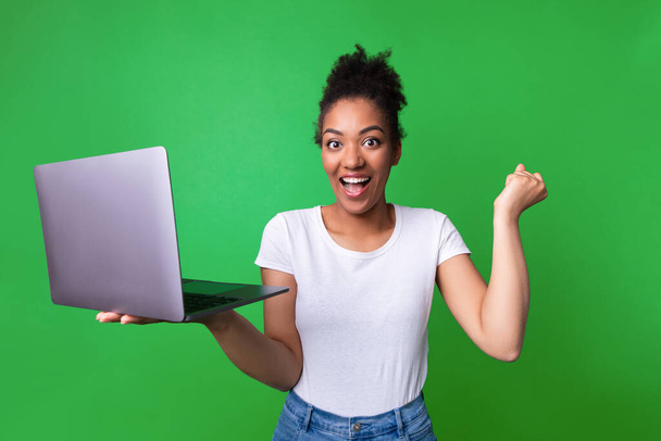 Excited black girl feeling ecstatic holding laptop - Photo, Image
