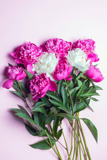 Bunch of white anf fuchsia peonies isolated on pink background. Flat lay composition, copy space, close up - Фото, зображення
