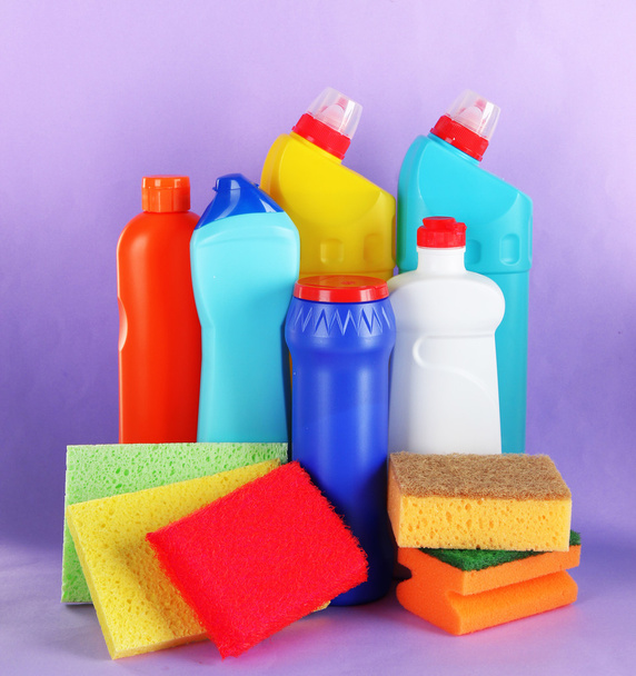 Different kinds of bath and toilet cleaners and colorful sponges, on color background - Photo, Image
