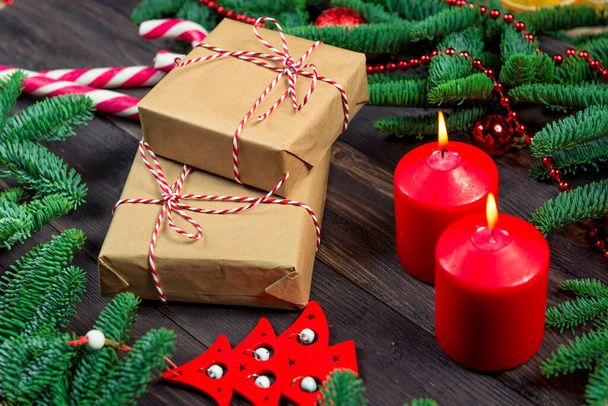 Декоративні різдвяні елементи поруч з подарунками для близьких на темному столі
 - Фото, зображення