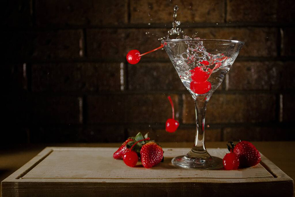 flying food martini alcoholic drink with red cherries - Photo, image