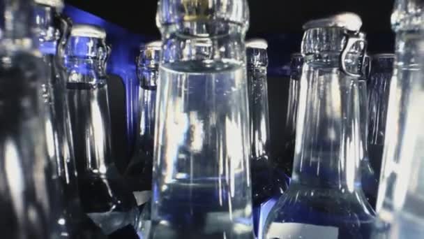 Row Of Clear Glass Bottles With Mineral Water Organized In Plastic Container With Hand Picking Up One Bottle.  - Footage, Video