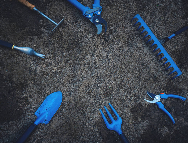 garden tools lie on black ground - Fotó, kép