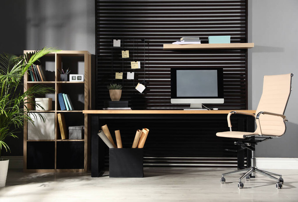 Comfortable workplace with computer and office chair. Stylish room interior - Foto, Imagem