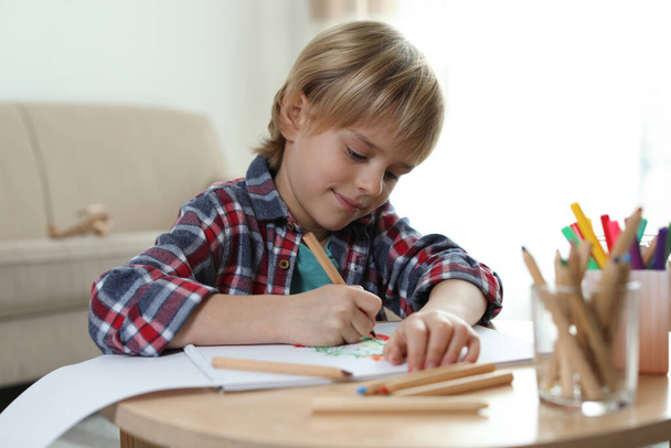 Little boy drawing at table indoors. Creative hobby - Foto, Bild