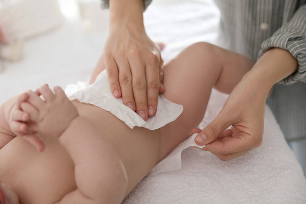 Mother changing her baby's diaper on table, closeup - Photo, Image