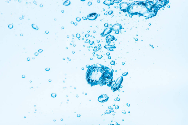 Bubbles in blue water background. - Zdjęcie, obraz