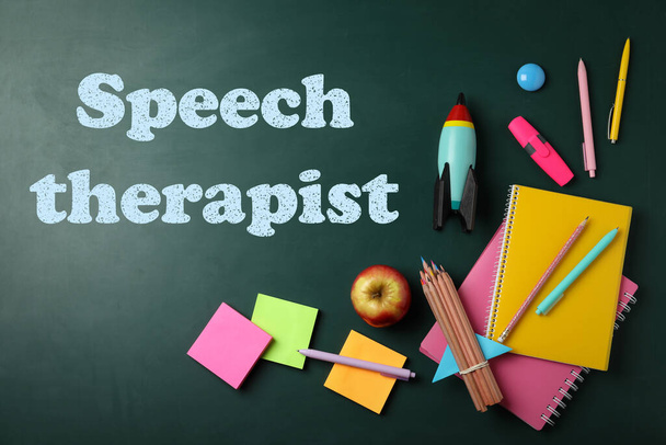 Bright toy rocket, school supplies and text Speech Therapist on chalkboard, flat lay  - Foto, imagen