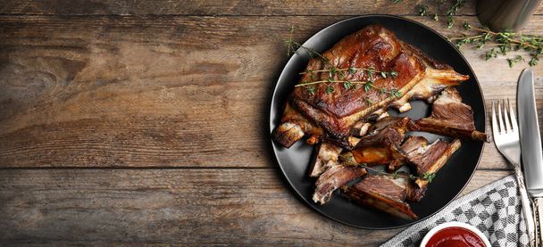 Flat lay composition with delicious roasted ribs on wooden table, space for text. Banner design - Zdjęcie, obraz