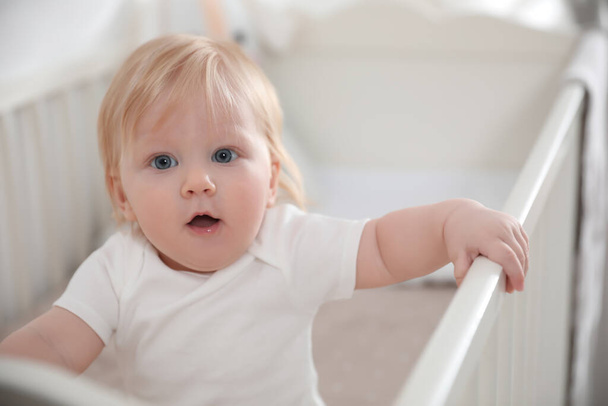 Cute little baby in crib at home - Foto, Bild