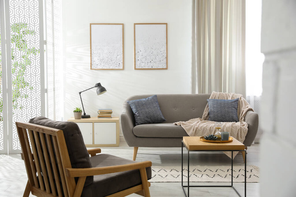 Modern living room interior with comfortable sofa and armchair - Φωτογραφία, εικόνα