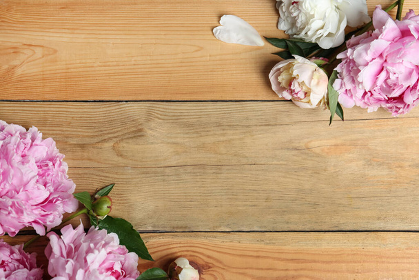 Beautiful peonies on wooden table, flat lay. Space for text - Φωτογραφία, εικόνα
