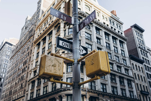 Buildings of New York City. Old architecture of Manhattan. Old fashioned buildings. Facades of New York. New York street pedestrian direction sign. Street name signs in Manhattan. Empty streets of New York City.  - Zdjęcie, obraz