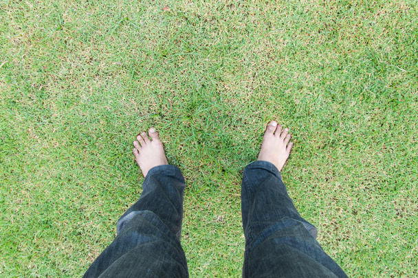 Foot over green grass - Photo, Image