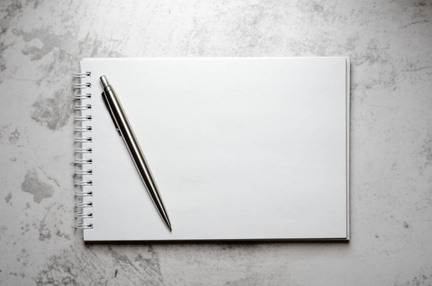 Notepad with metal gray pen on a stone background. Concept elegant business style. Copy space, top view, flat lay - Φωτογραφία, εικόνα