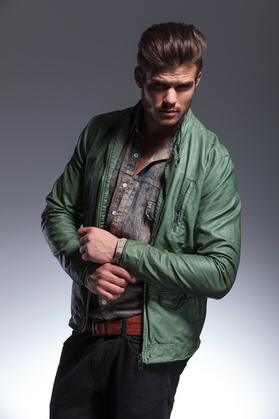 young man in leather jacket fixing his sleeve - Photo, Image