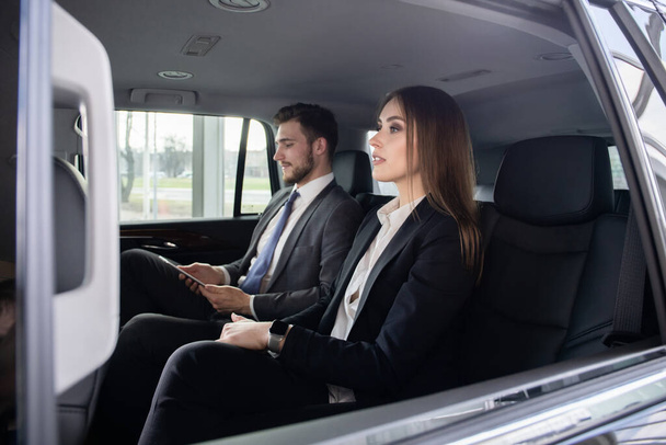 Conversation of two business people in driving car - Photo, Image