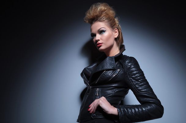 woman in leather clothes standing with hands on hips and looking - Foto, Imagem