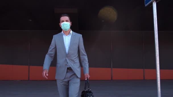 Elegant businessman wearing protective mask in airport. Young mail entrepreneur in formalwear. Pandemic, new rules of control, business trip and traveling concepts. - Filmati, video