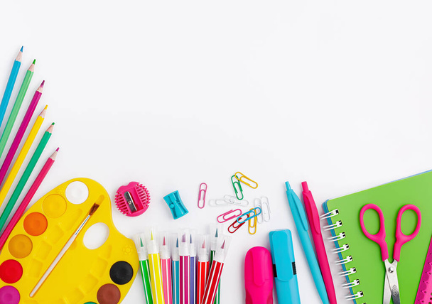 Colorful school supplies and stationery on white background. Copy space, top view. Back to school concept. - Фото, зображення