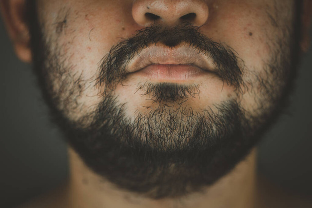 Close up half face of a Asian man with a beard and thick mustache - Zdjęcie, obraz