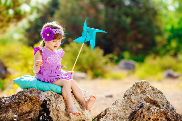 Adorable toddler girl playing outdoors in green summer park - Photo, image
