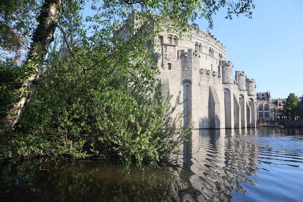 The medieval castle of the counts of Flanders Gravensteen, view from the river.Scenic panorama of the old fortress, reflected in the water, the ancient castle Gravensteen, Ghent, Belgium - Photo, Image