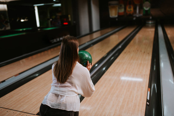 Beautiful caucasian girl on a bowling alley track - Zdjęcie, obraz